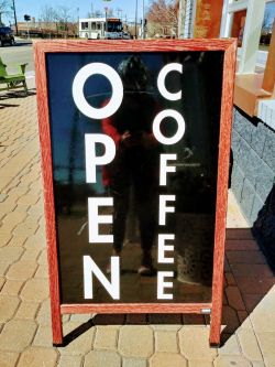 The 205 Coffee Shop is open for coffee. The 205 Coffee Shop sign